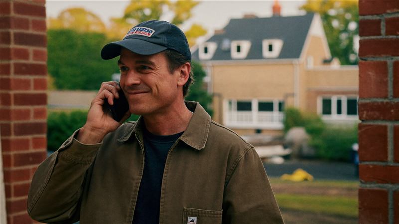 Builder taking a customer call on site